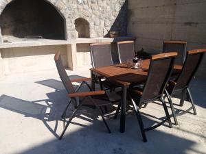 a wooden table and six chairs sitting around it at NATALIJA - holiday house with garage in Sveti Juraj