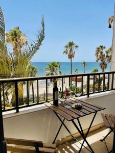 a table on a balcony with a view of the beach at Apartamento frente a la playa Piso 3 in Estepona