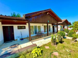 a home with a porch and a house at Alexander Bungalows in Shkorpilovtsi