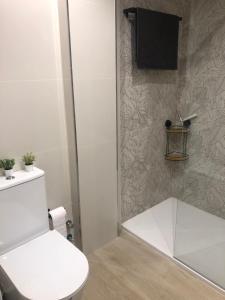 a bathroom with a white toilet and a shower at Vcc Home’s in Puerto de Mazarrón +19 photos