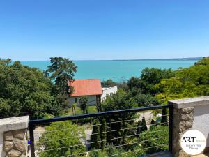 a view of the ocean from the balcony of a house at ARTtrend Luxury Villa in Tihany
