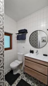 a bathroom with a toilet and a sink and a mirror at Panorama Hotel & SPA in Chernivtsi