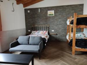 a room with a couch and a bunk bed at La Leñera in San Pascual +7 photos