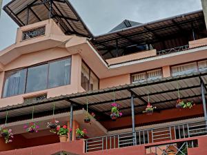 a building with potted plants on the side of it at HAVEN COTTAGE in Ooty