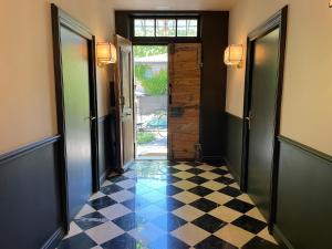 a hallway with a checkered floor and an open door at Villa Amara in Aix-en-Provence +25 photos