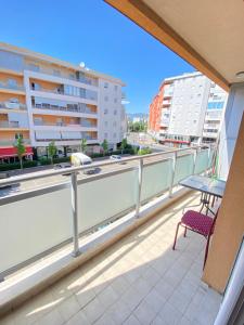 a balcony with a chair and a building at Apartman Vesna City 2. PG in Podgorica
