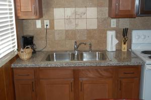 a kitchen with a sink and a counter top at El Rancho Motel in Bishop +37 photos
