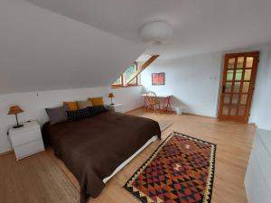 a bedroom with a large bed in a room at Erdőszéli Vendégház Zebegény in Zebegény