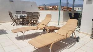 a group of chairs and a table on a roof at Casa Toboso 2 in Torre del Mar