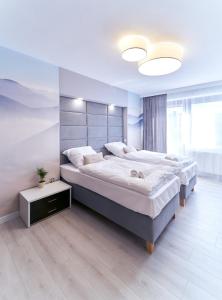 Ein Bett oder Betten in einem Zimmer der Unterkunft Apartament Horyzont 3 Mariańska