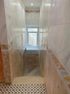 a bathroom with a staircase and a window at Concept Guest House in Elvas