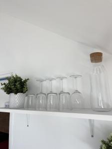 a white shelf with glassases on top of it at Cοcοοn in Dinan