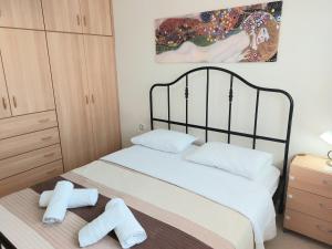 a bedroom with a bed with two towels on it at Argiro's Apartment in Iraklitsa