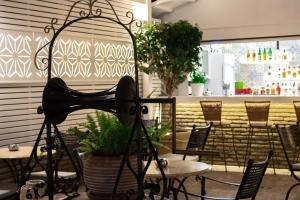 a restaurant with tables and chairs and a table sidx sidx at Armata Boutique Hotel in Spetses