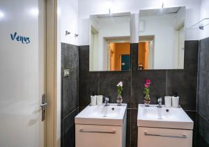 a bathroom with two sinks and a mirror at Madà B&B in Naples +26 photos