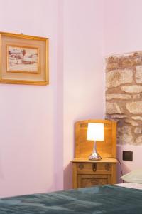 A bed or beds in a room at Alla Porta Di Sotto B&B