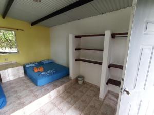 a room with two bunk beds and a door at Boca Brava Lodge in Boca Chica