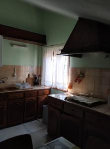 a kitchen with a sink and a stove top oven at Sousa e Inês House in Gafanha da Nazaré