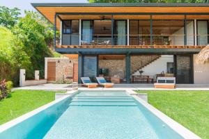 a house with a swimming pool in front of a house at Casa Mirame in Carmen