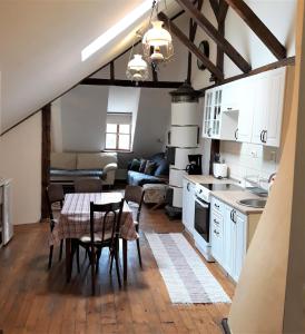 a kitchen and living room with a table and chairs at Casa Cojo in Sighişoara