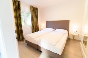 a bedroom with a large bed and a window at Seeappartements Christiane Haus 97 in Krumpendorf am Wörthersee