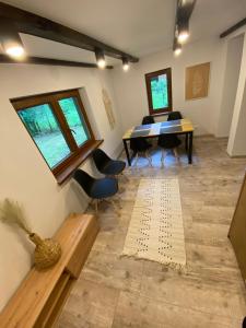 a dining room with a table and chairs at Antonówka in Woryty