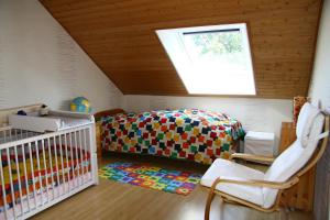 a room with a crib and a skylight at Ferienwohnung Klosterblick in Homburg