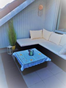 a bench sitting on a porch with a table at Ferienwohnung Klosterblick in Homburg