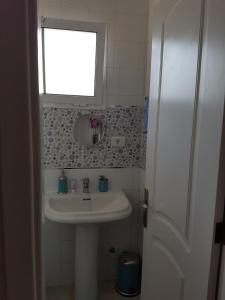 a small bathroom with a sink and a mirror at Unamuno in Puerto del Rosario