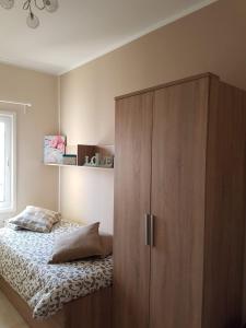 a bedroom with a large wooden cabinet next to a bed at Unamuno in Puerto del Rosario