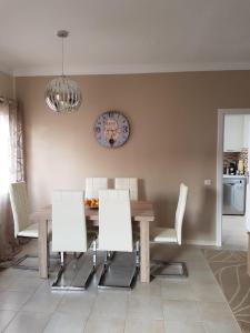 a dining room with a wooden table and chairs at Unamuno in Puerto del Rosario