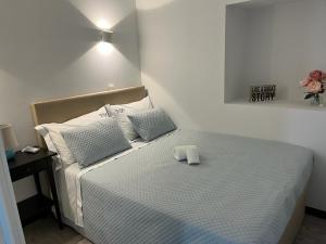 a bedroom with a bed with a towel on it at Casa Beira Rio in Viana do Castelo