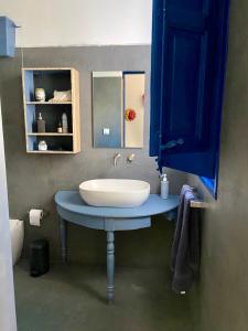 a bathroom with a sink and a blue cabinet at Casa Marietta in San Vito lo Capo +25 photos