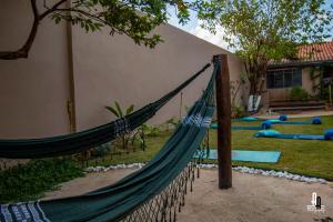 a hammock in a yard next to a house at Ashram Anandini in Campinas