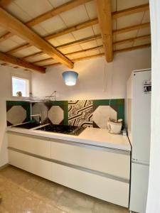 a kitchen with a stove and a refrigerator at Casa Marietta in San Vito lo Capo