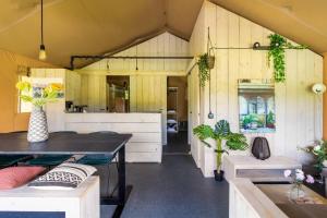 a kitchen and dining room of a tiny house at Glamping lodge with Eco-Wellness in Zeewolde