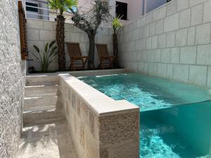a swimming pool with a concrete retaining wall and stairs at Villa Charles in Trogir