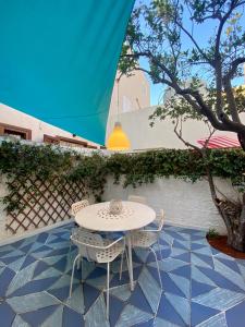 a table and two chairs on a patio at Casa Marietta in San Vito lo Capo