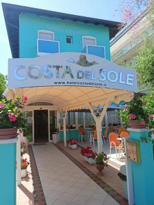 a sign for a costa cell sale in front of a building at Costa del Sole Only Room in Milano Marittima