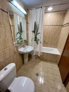 a bathroom with a toilet and a sink and a tub at Мезонет Лапландия in Pamporovo +22 photos