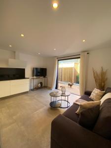 a living room with a couch and a large window at La Verda in Bonifacio