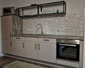 a kitchen with a sink and a stove at FeWo Johan - ideal für 1-2 Personen, eigene Terrasse in Hamm