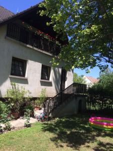 Haus mit Balkon und Hof mit Frisbee in der Unterkunft Apartment Orvenyes 1 in Örvényes