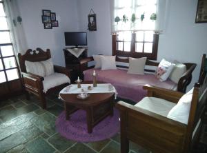 a living room with a bed and a table and chairs at Panoramic Views Home in Hydra, Greece in Hydra
