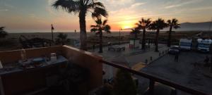 a sunset over a parking lot with palm trees at Apartamento 34 La Tortuga I in Tarifa +3 photos