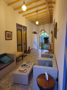 a living room with three couches and a table at Alegria Hostel Boutique in Guatapé
