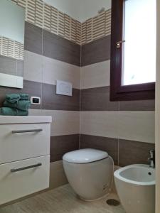 a bathroom with a toilet and a sink at Green Palace in Brindisi +24 photos