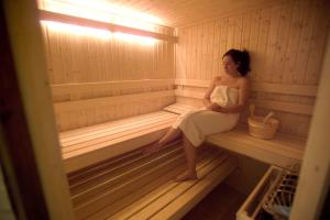 a woman is sitting in a sauna at Ray's Bucktown Bed and Breakfast in Chicago