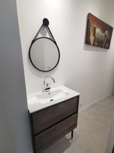 a bathroom with a sink and a mirror on the wall at Indè Noi - Maison de village proche commodités in Murato