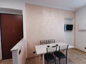 une salle à manger avec une table et des chaises blanches dans l'établissement HappyHome, Belissimo appartamento in Torino, à Turin